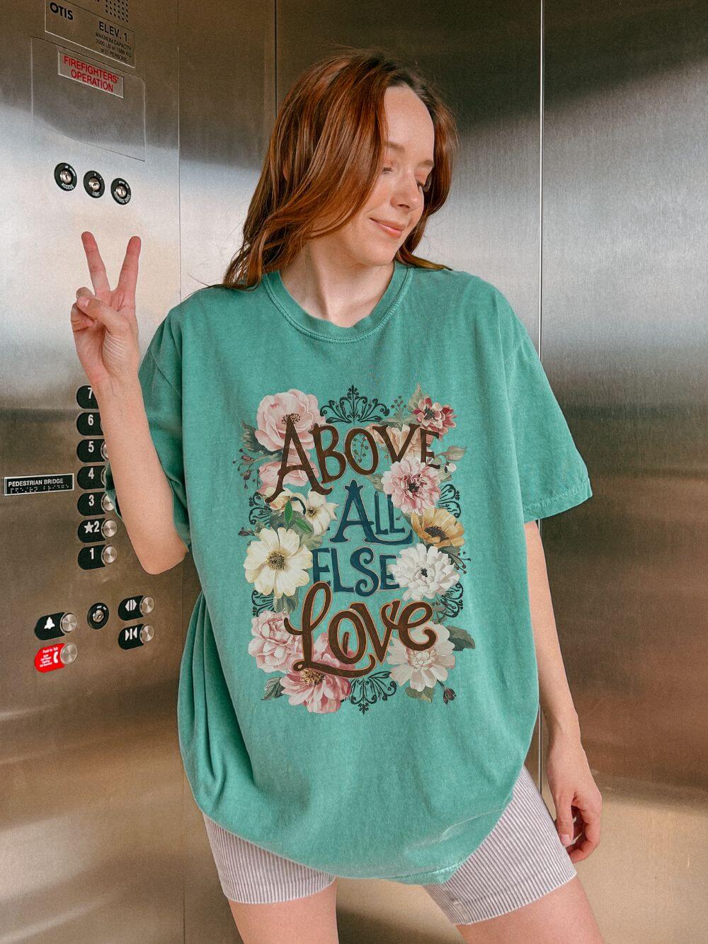 Above_All_Else_Love_Light_Green Above All Else Love T-Shirt Floral Vintage Christian Graphic Tee - Image 1
