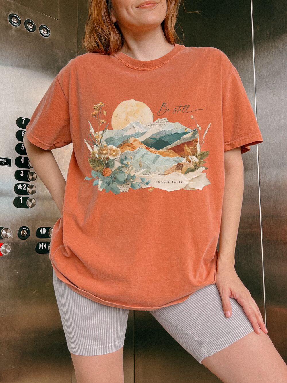 Be_Still_Yam_f877fcfa-1808-473f-8c87-ee33f5de9281 Be Still & Know Psalm & Mountains Graphic T-Shirt Christian Tee - Image 1
