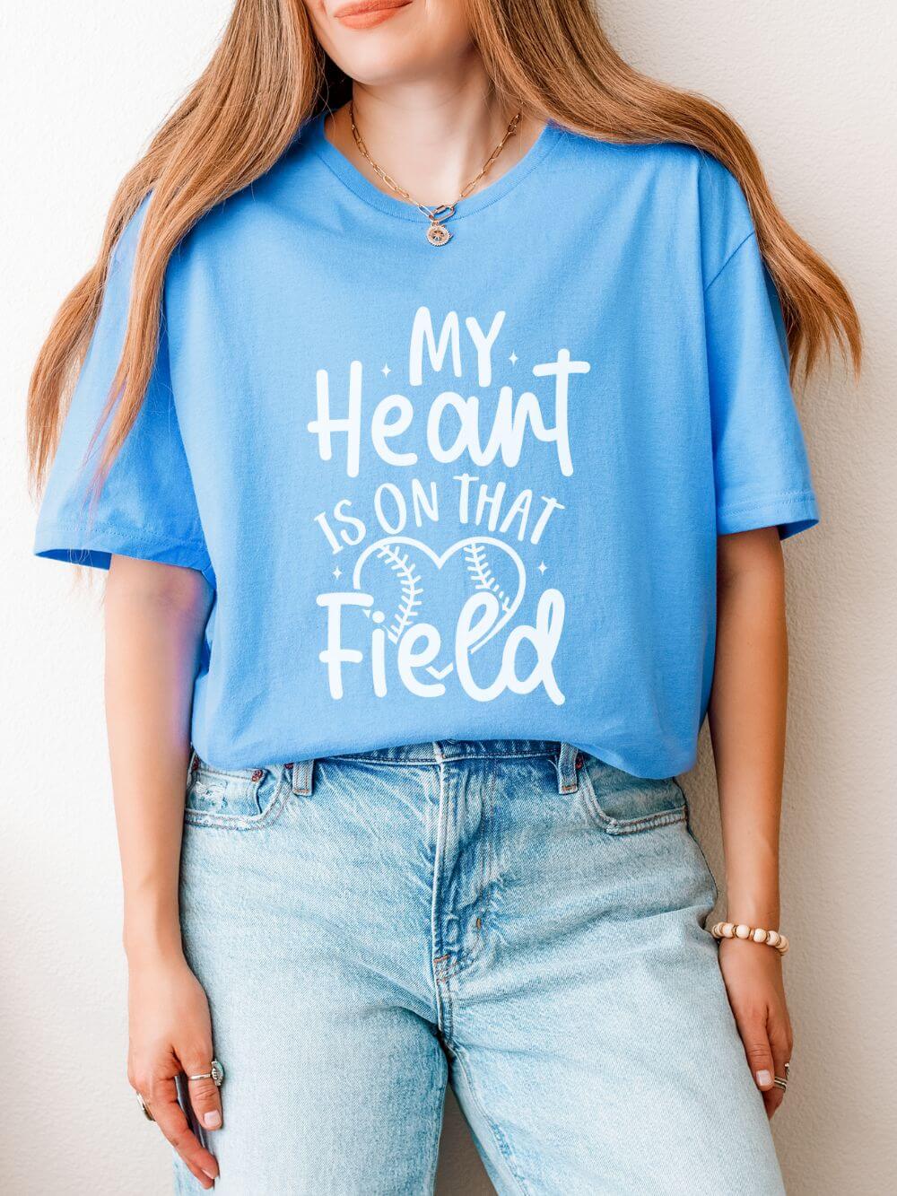 Heart_on_Field_Carolina_Blue My Heart is On That Field Baseball or Softball Graphic T-Shirt Cute Sports Mom Tee (12 Team Colors) - Image 1