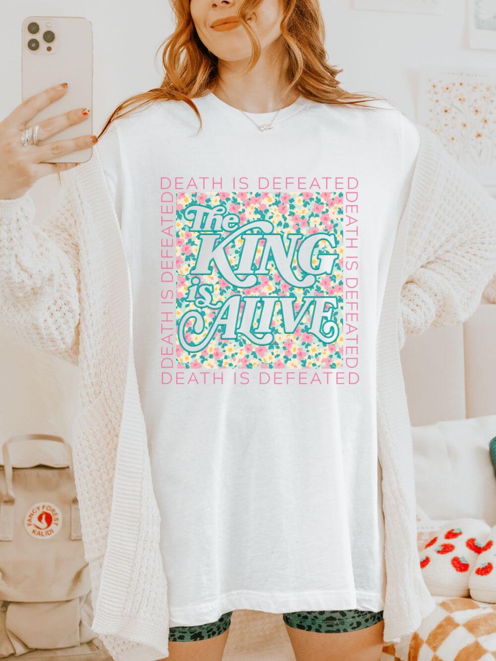 King_is_Alive_White The King Is Alive Floral T‑Shirt Death Is Defeated Christian Easter Graphic Tee - Image 1