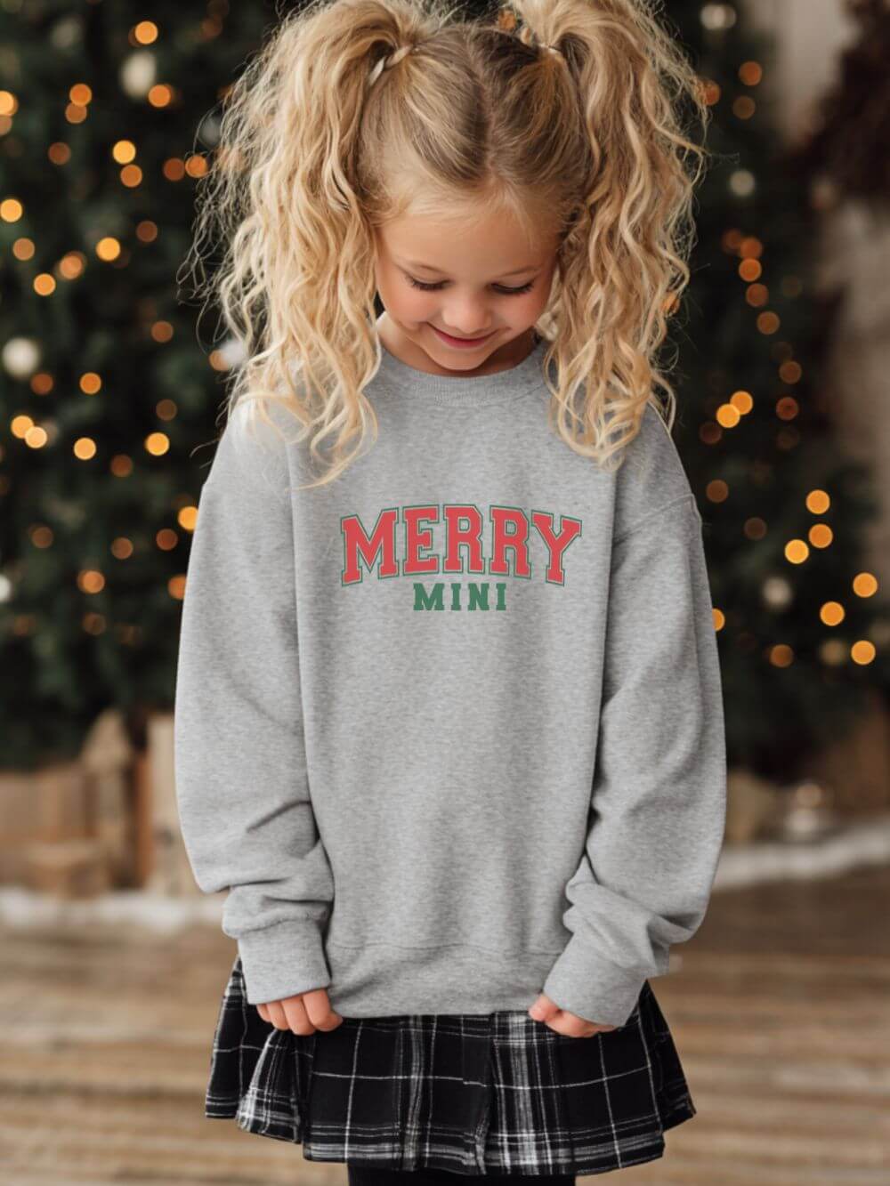 Merry_Mini_Sport_Gray Merry Mini Heavy Blend Kids' Crewneck Graphic Christmas Holiday Sweatshirt - Image 1