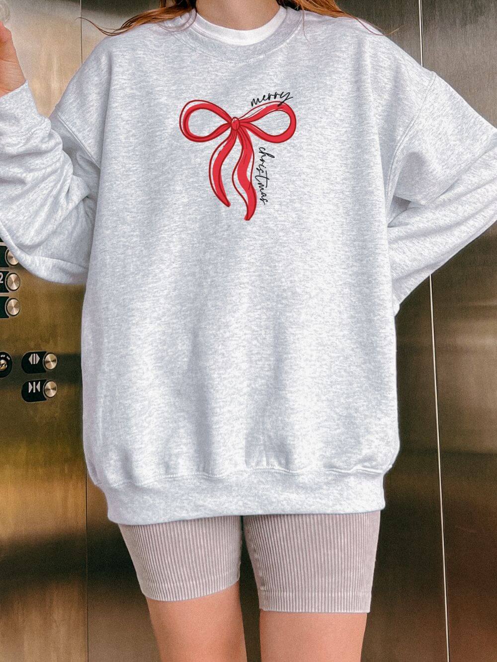 Red_Bow_Merry_Christmas_Ash Red Bow Merry Christmas Heavy Blend Unisex Crewneck Cozy Holiday Sweatshirt - Image 1