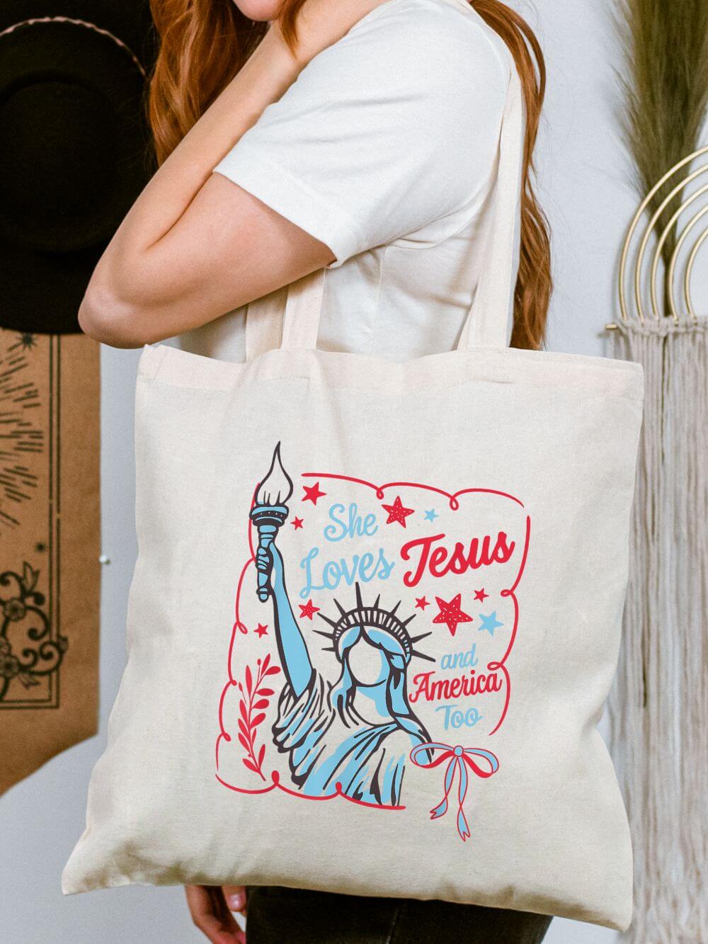 She_Loves_Jesus_America_Statue_Tote She Loves Jesus and America Too Statue of Liberty Patriotic Canvas Tote Bag - Image 1