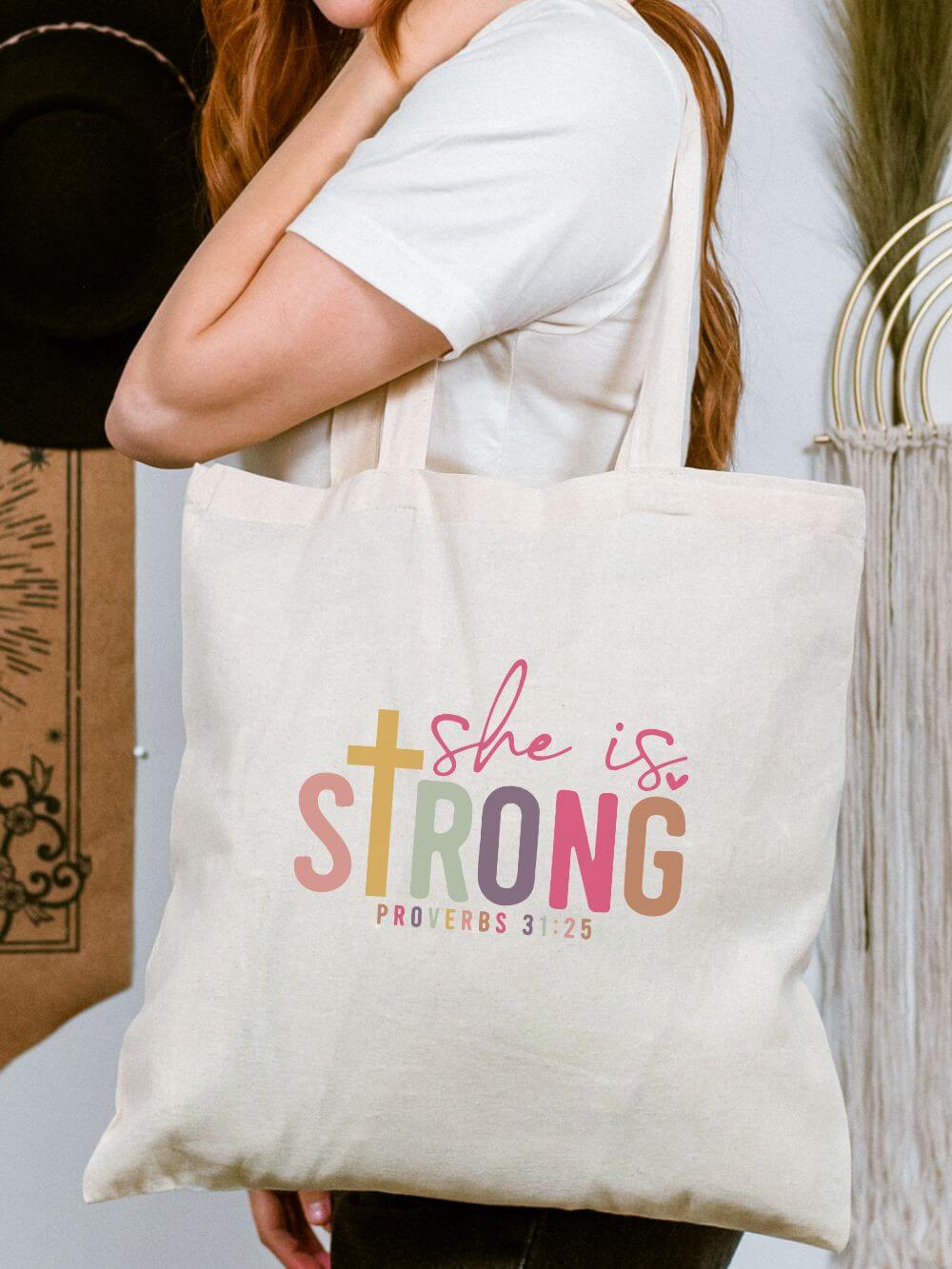 She_is_Strong_Tote She Is Strong Proverbs 31:25 Inspirational Cotton Canvas Tote Bag - Image 1